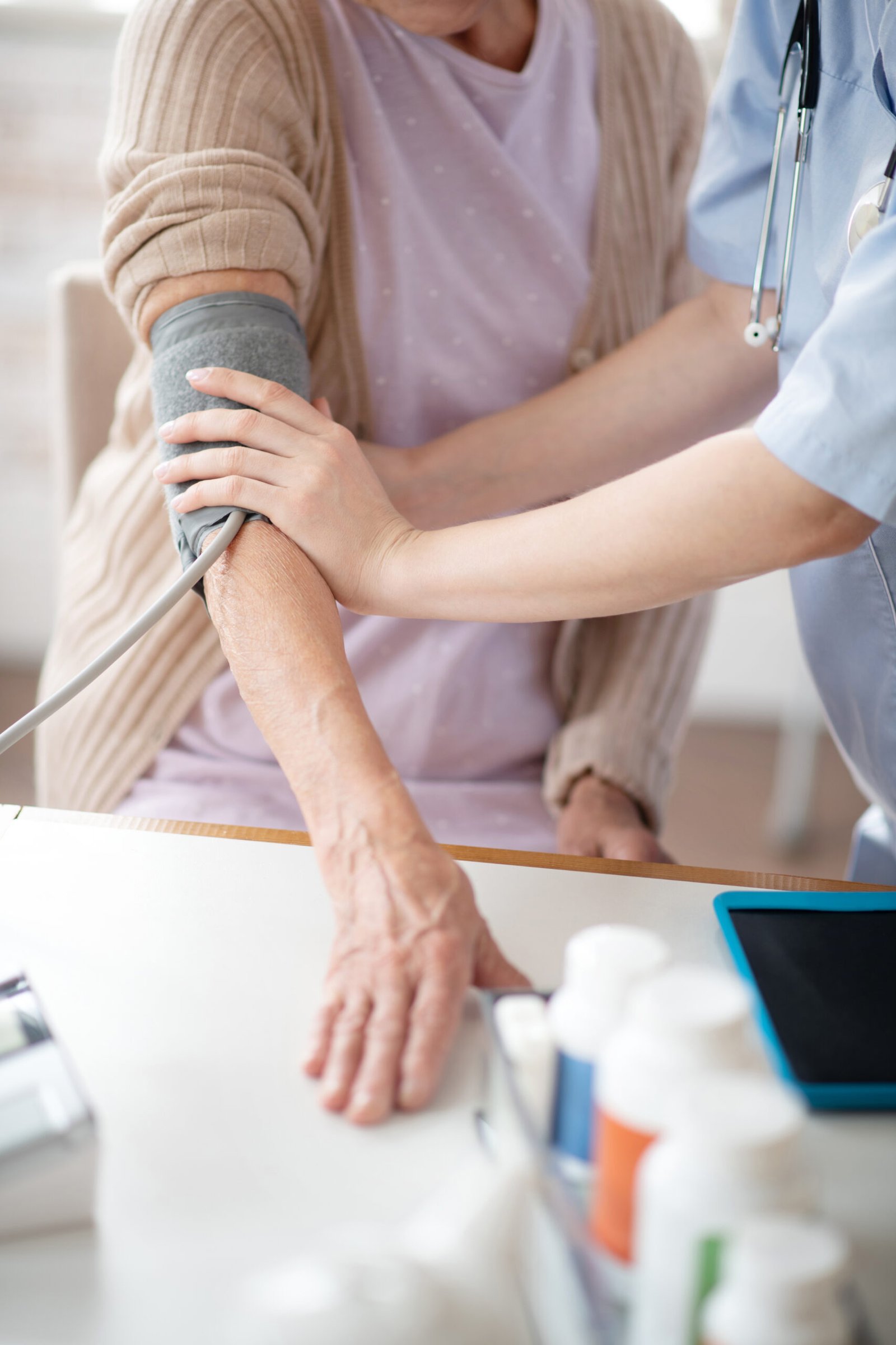 Medical worker measuring blood pressure for woman